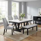 Dining room with a marble table, gray chairs, and a bench.