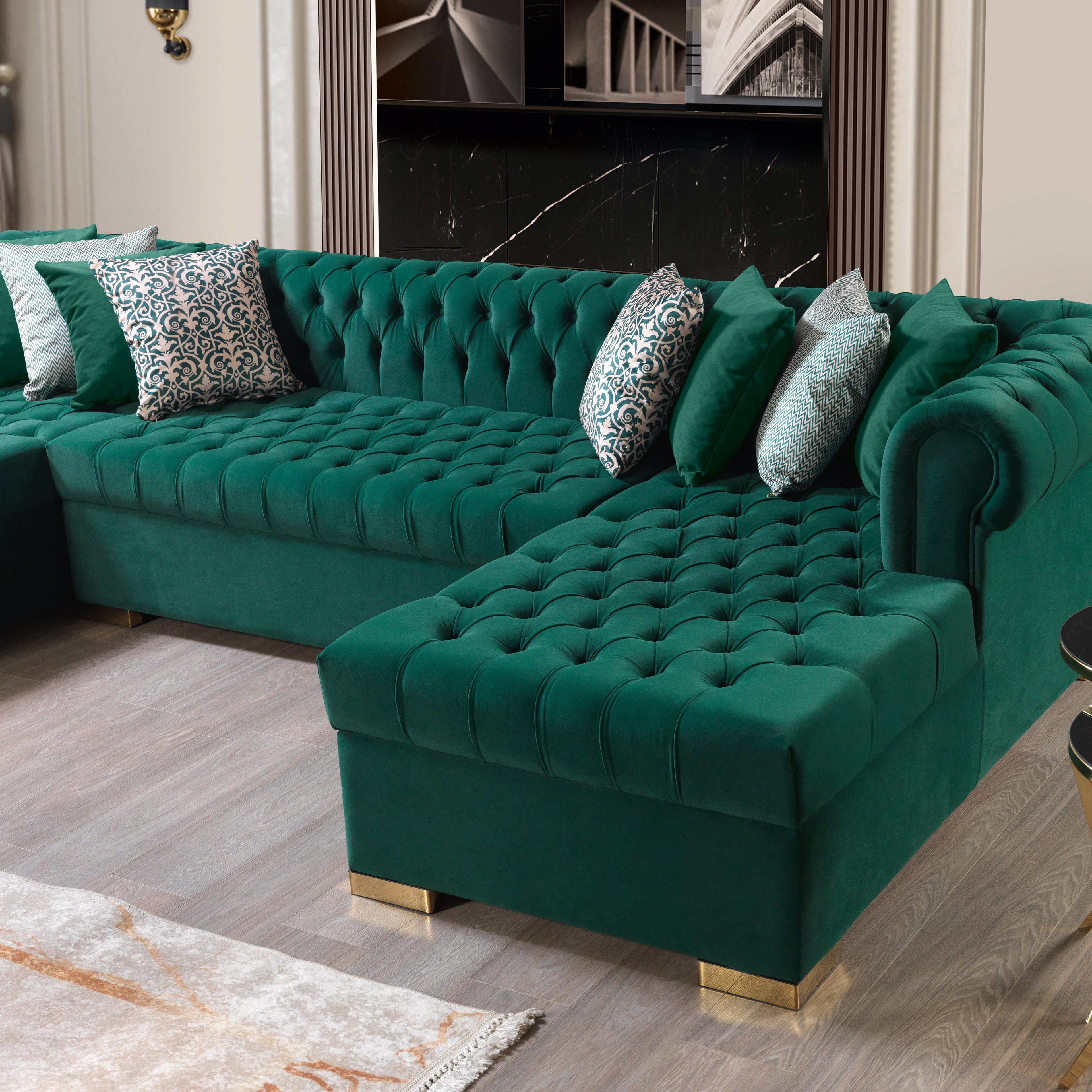 Green velvet sectional sofa with decorative pillows in a living room setting.