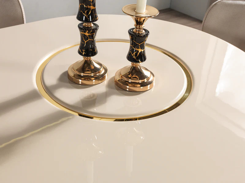 Decorative candle holders on a round tray with gold rim on a white table.