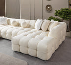 White textured sofa with decorative pillows in a modern living room setting.