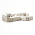 Beige sectional sofa with patterned cushions on a white background