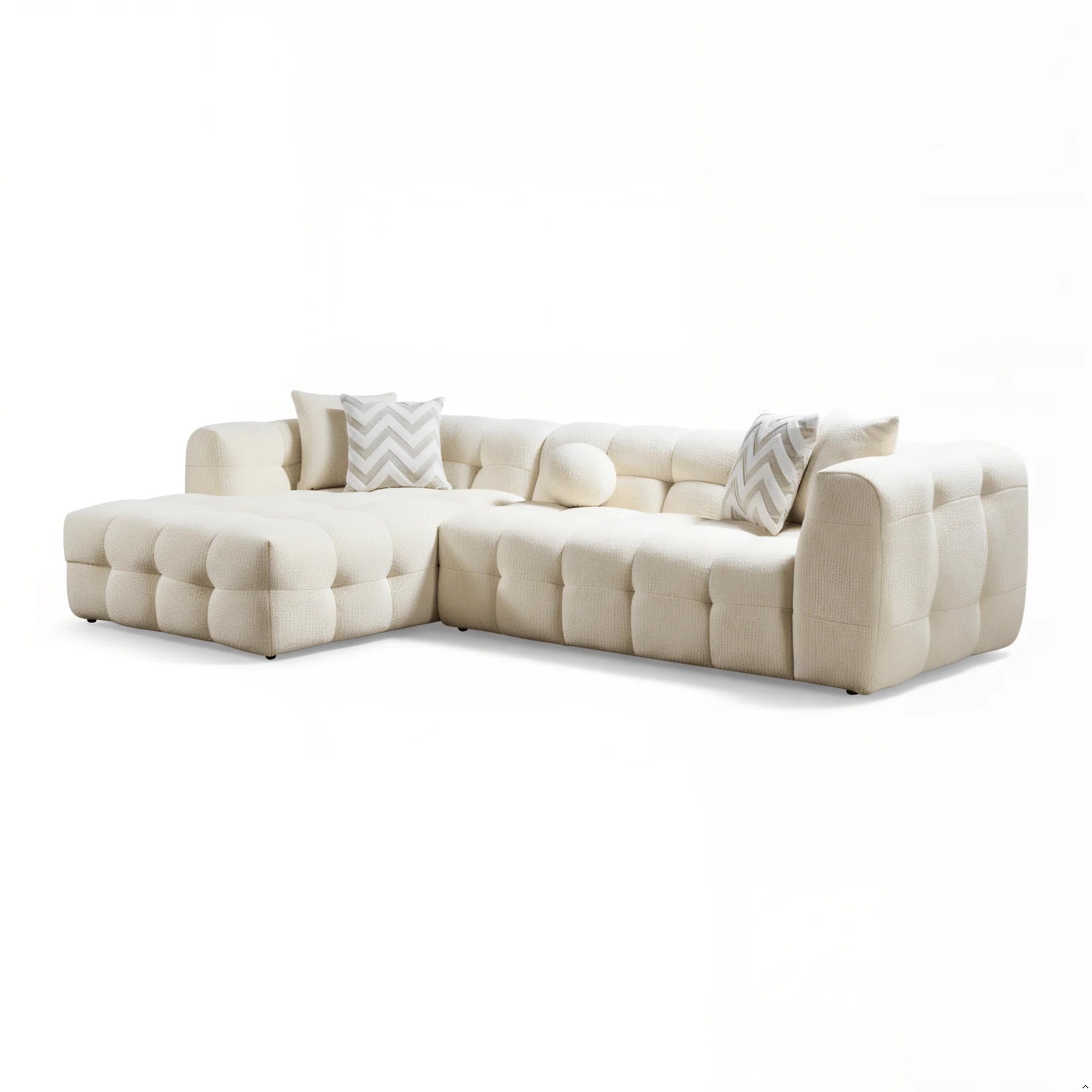 Beige sectional sofa with patterned cushions on a white background