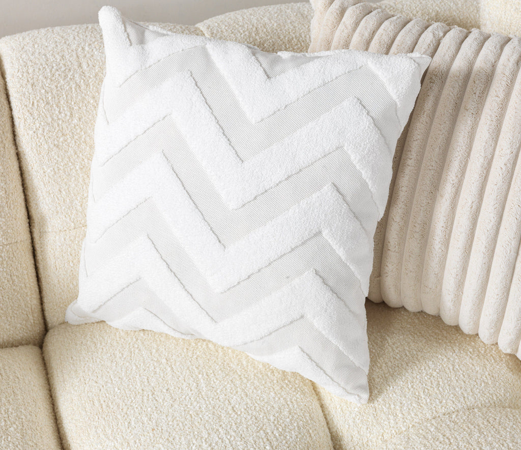 White chevron-patterned pillow on a beige sofa