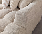 Close-up of a textured beige sofa with cushions.