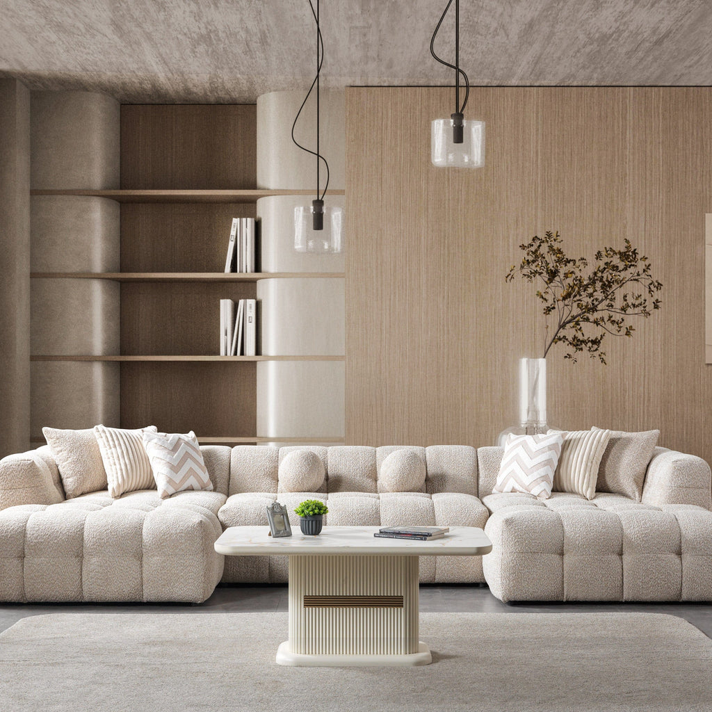Modern living room with a beige sectional sofa, coffee table, and decorative elements.