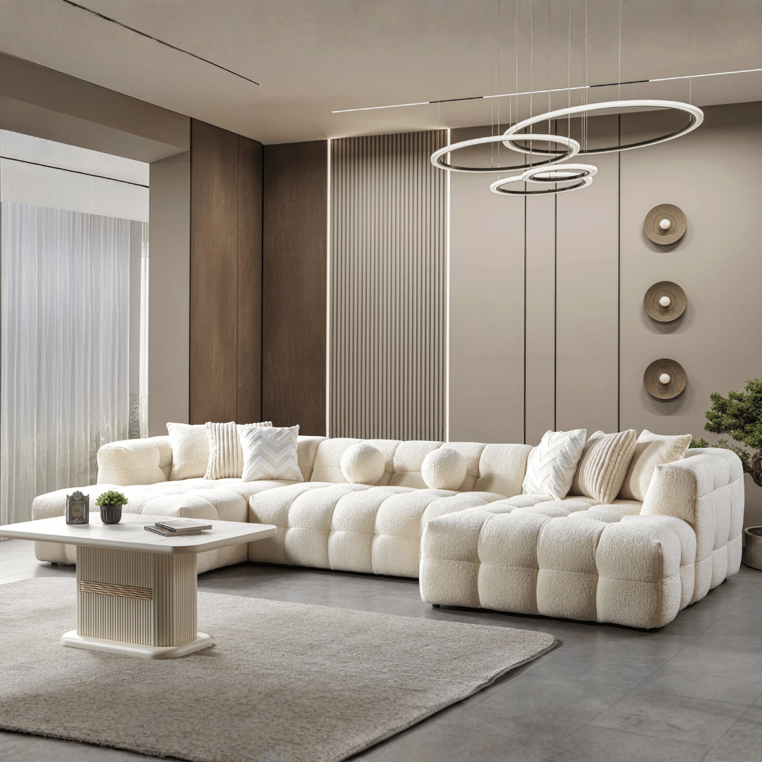 Modern living room with a large white sectional sofa, coffee table, and decorative elements.