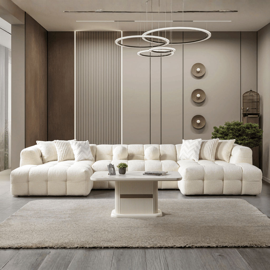 Modern living room with a white sectional sofa, coffee table, and decorative elements.