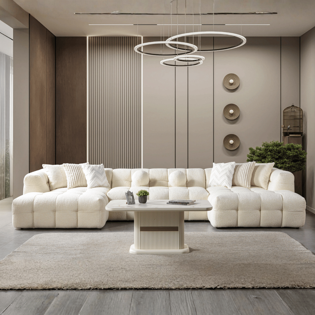 Modern living room with a white sectional sofa, coffee table, and decorative elements.