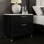 Black nightstand with white lampshade in a bedroom setting