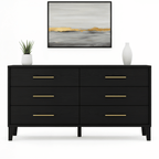 Black dresser with gold handles in a room setting with a painting and plants.