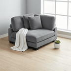 Gray sofa with a white blanket in a room with a window and plant