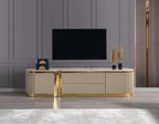 Modern entertainment console with gold accents in a room with a television.