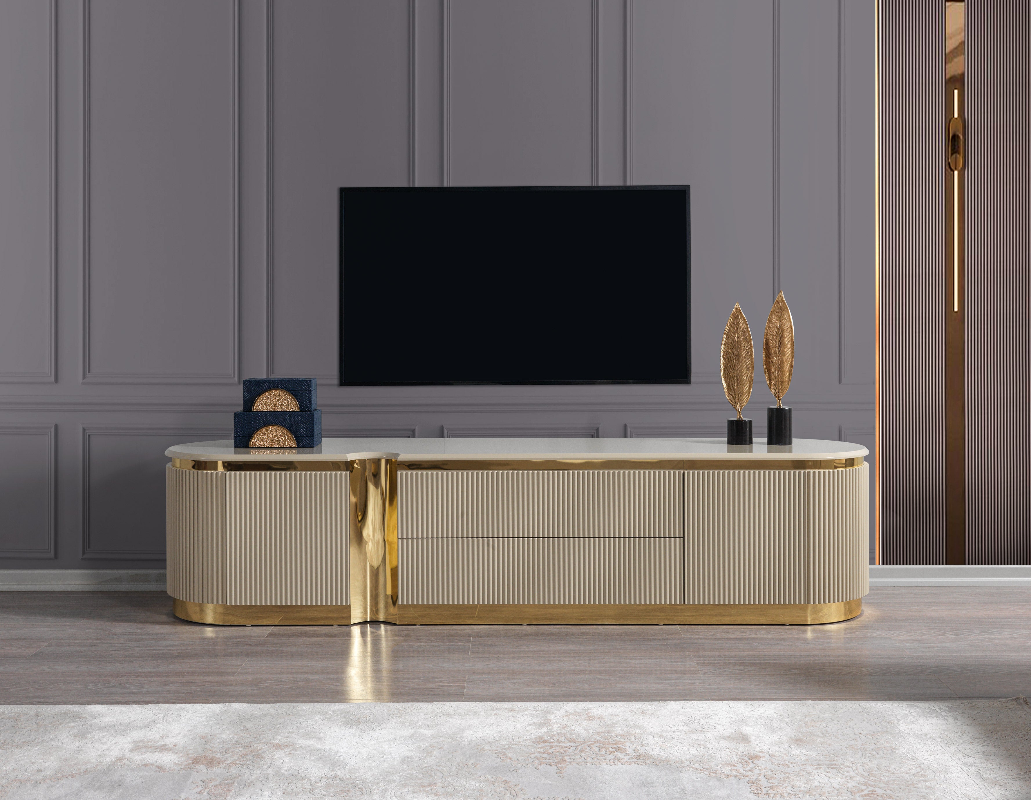 Modern entertainment console with gold accents in a room with a television.