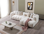 White sectional sofa in a living room with a coffee table and decorative items.