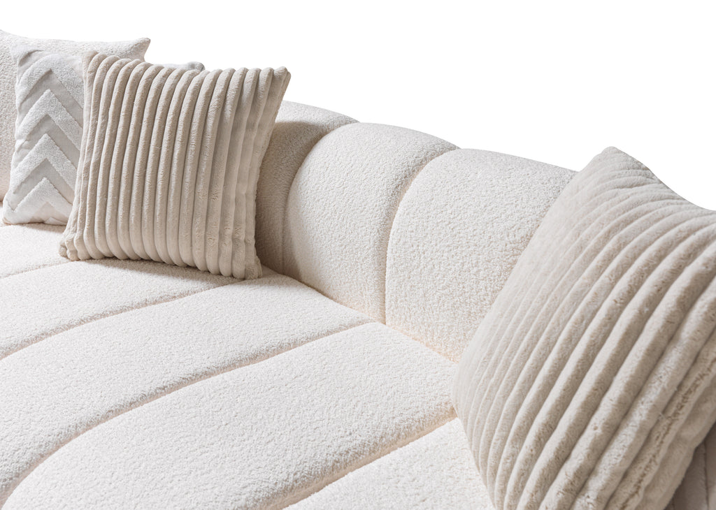White textured sofa with decorative pillows on a white background
