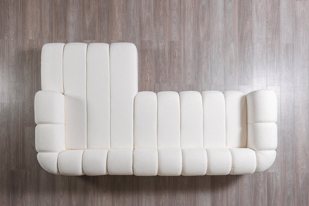 White tufted sofa on a wooden floor
