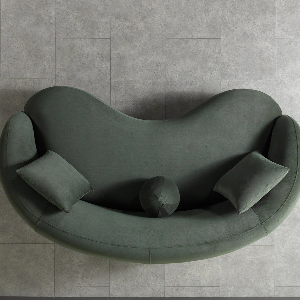 Modern green sofa on a gray tiled floor
