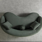 Modern green sofa on a gray tiled floor