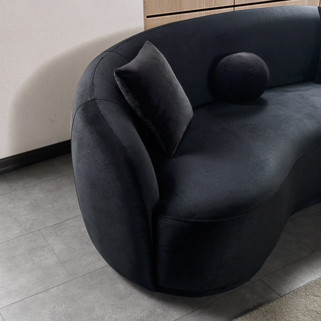 Modern black sofa with a textured surface in a minimalistic room.