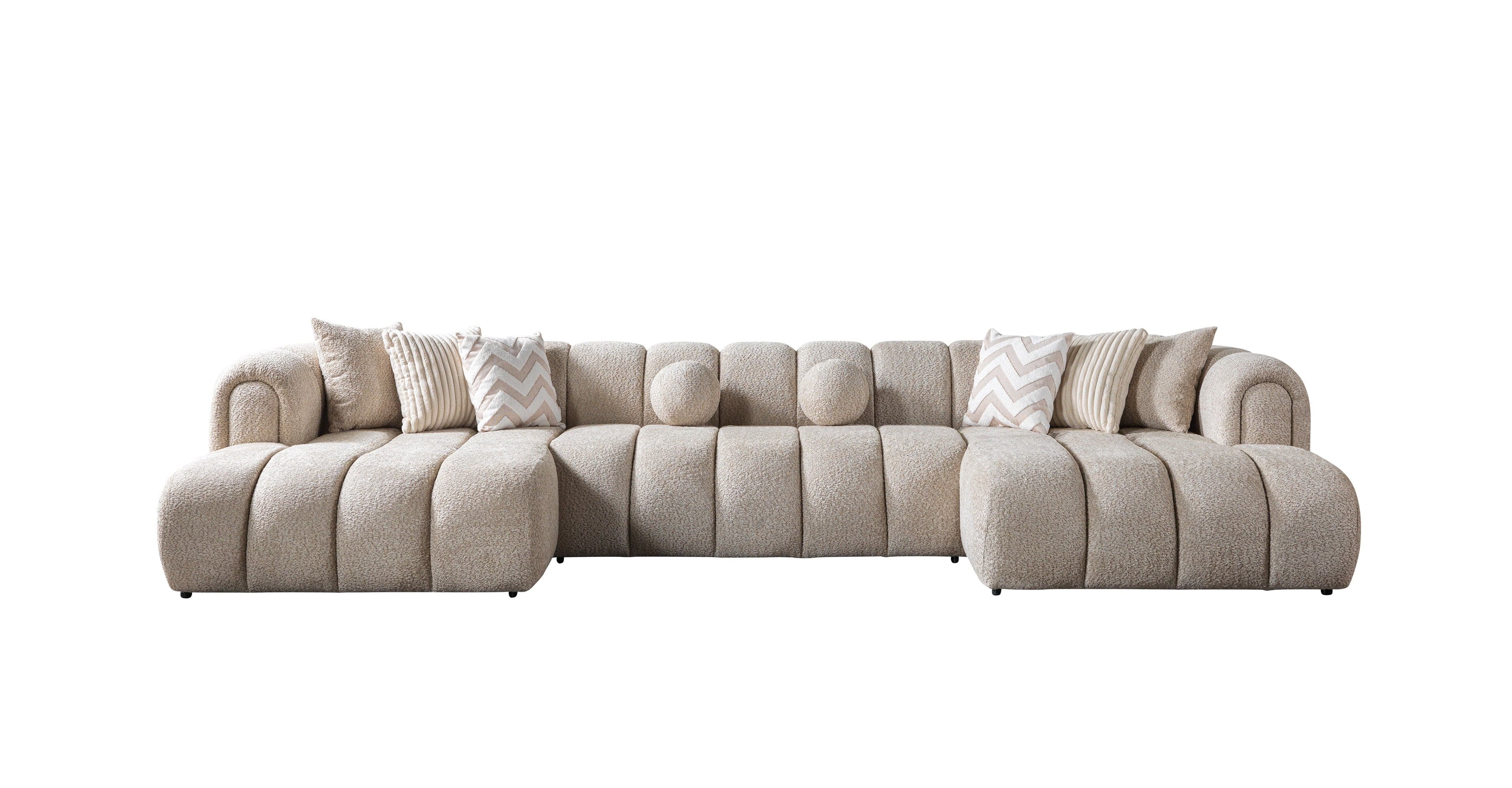 Beige sectional sofa with patterned cushions on a white background