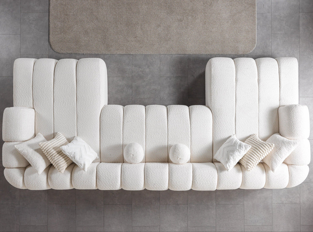 Modern white sofa with cushions on a gray floor