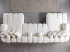 Modern white sofa with cushions on a gray floor