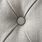 Close-up of a textured gray fabric surface with a button-like design.