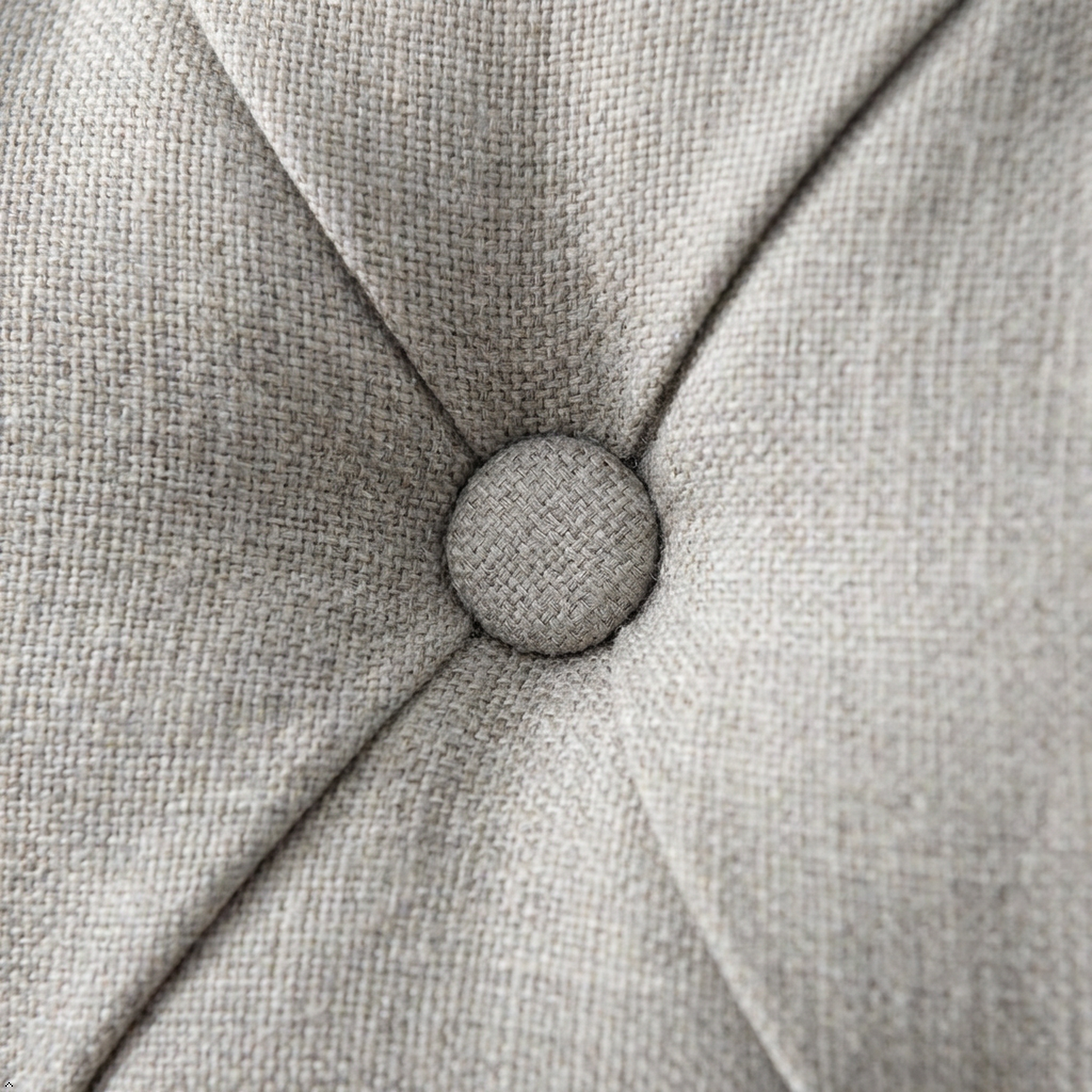 Close-up of a textured gray fabric surface with a button-like design.