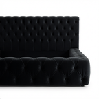 Black tufted sofa on a white background