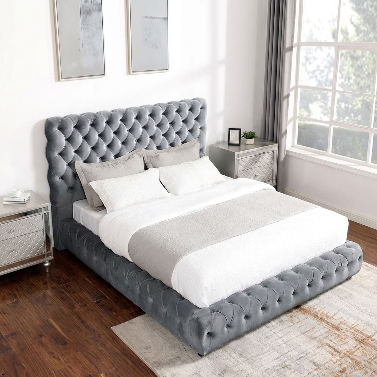 Gray tufted bed with white bedding in a bedroom setting
