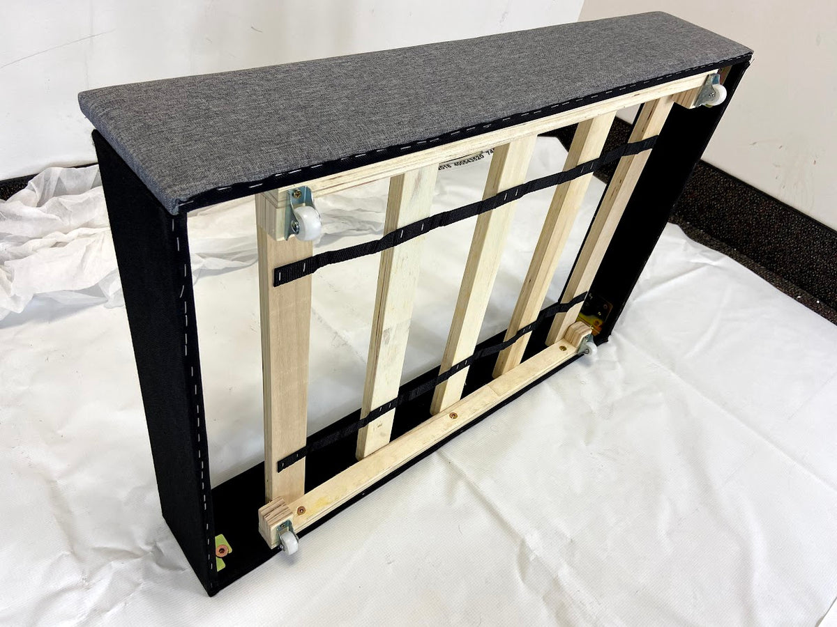 Wooden pet gate with black top and base on a white background