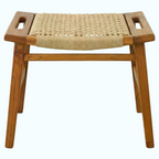 A wooden folding stool with a woven natural fiber seat and integrated side handles, shown on a plain white background.