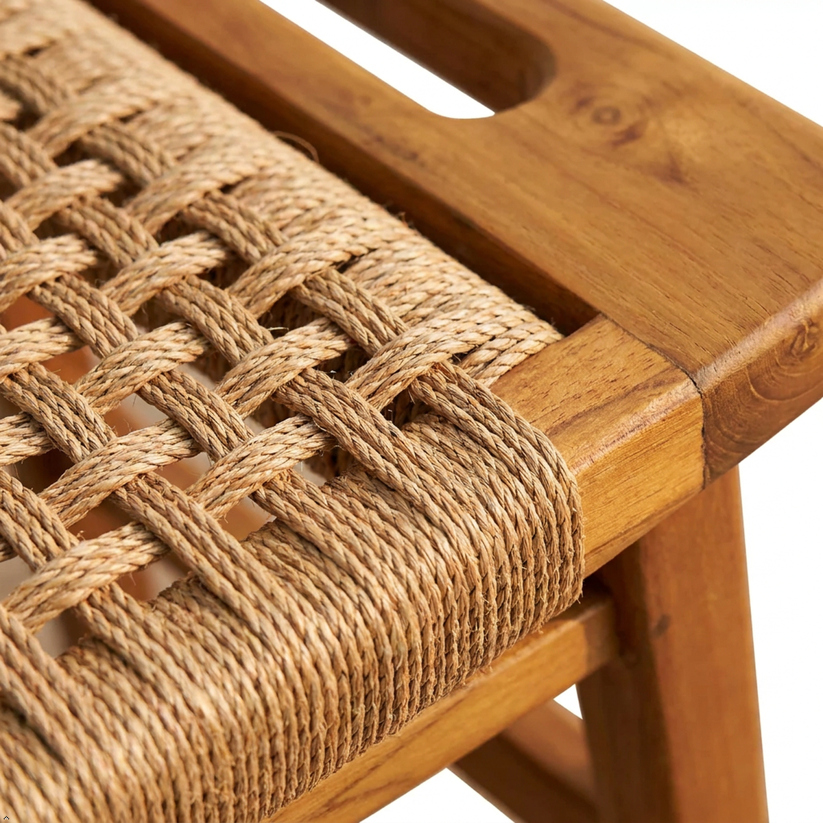 Close-up of a wooden bench or stool with a woven natural fiber seat, showing the warm brown wood frame and tan rope texture against a white background.