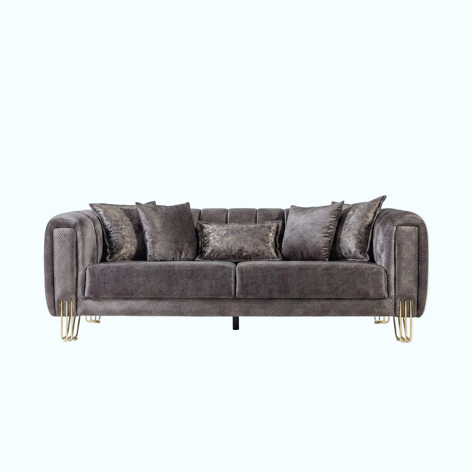 A modern three-seater sofa upholstered in textured charcoal gray fabric with matching throw pillows, featuring slim gold metal legs, shown against a solid light blue background.