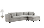 Gray sectional sofa in a living room with a rug and decor items.
