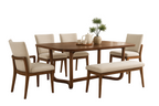 Dining room with wooden table and chairs in a well-lit room.
