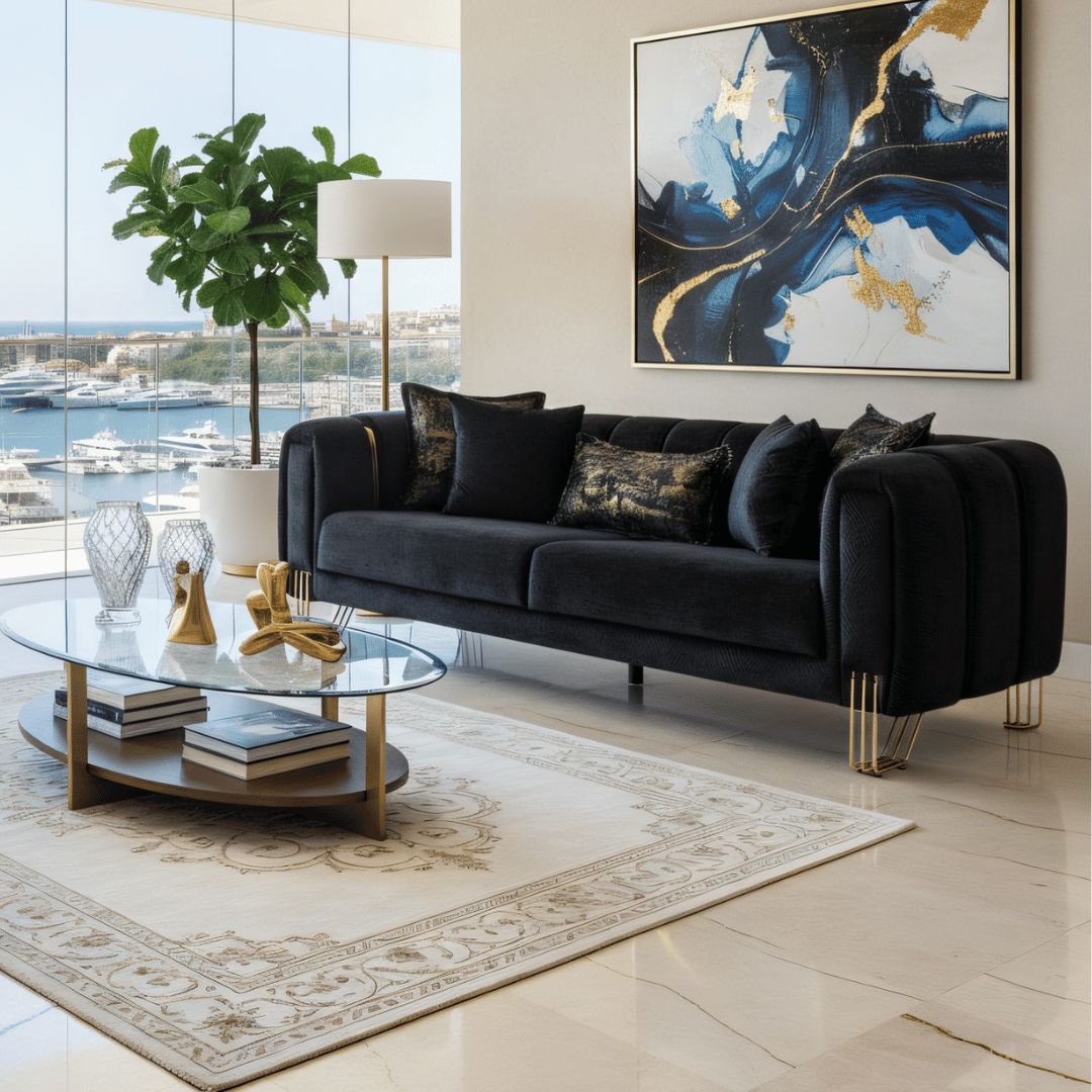 Modern living room with a black sofa, glass coffee table, and abstract art on the wall.