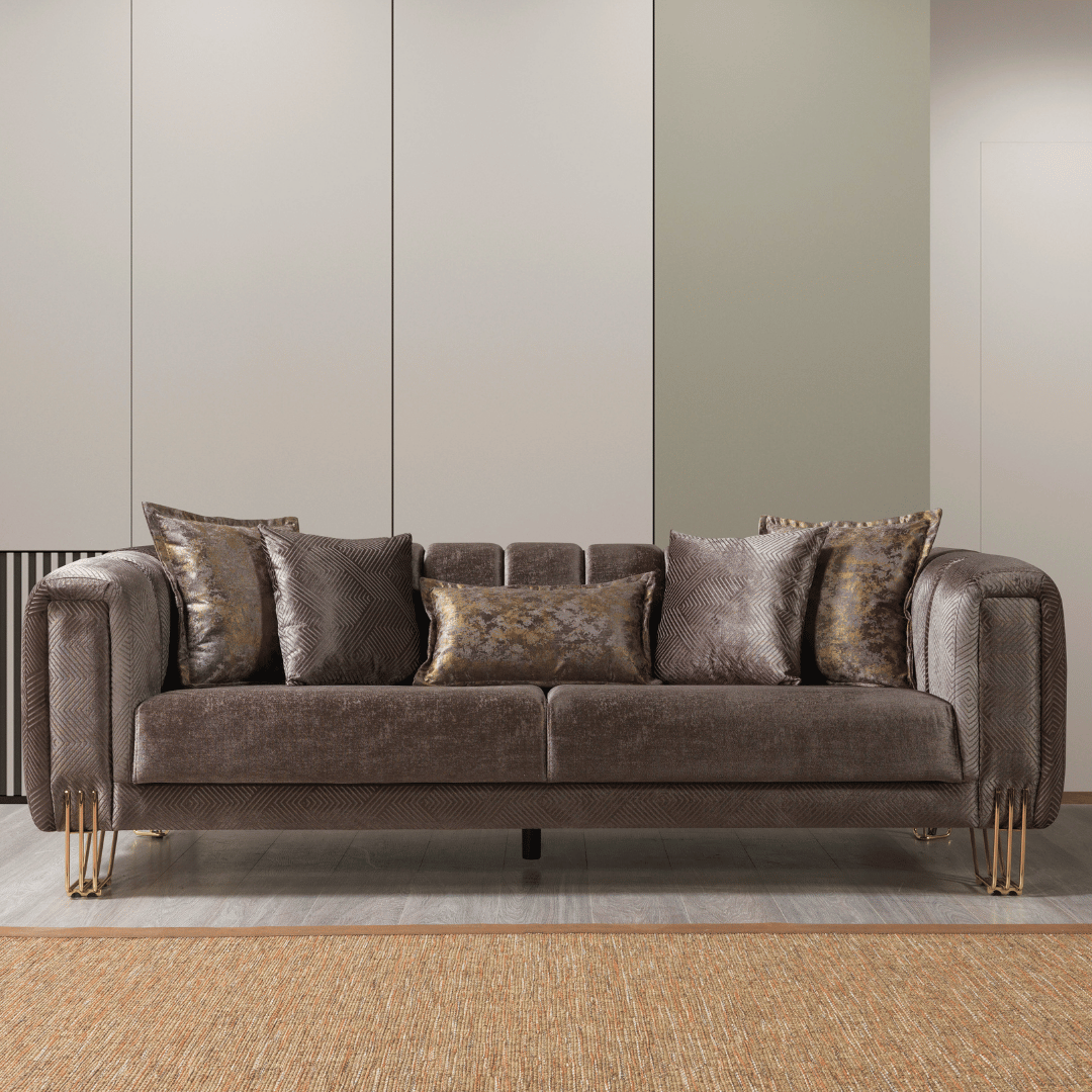 Brown sofa with decorative pillows in a room with a neutral color scheme.