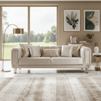 Beige sofa in a living room with large windows and decorative elements.