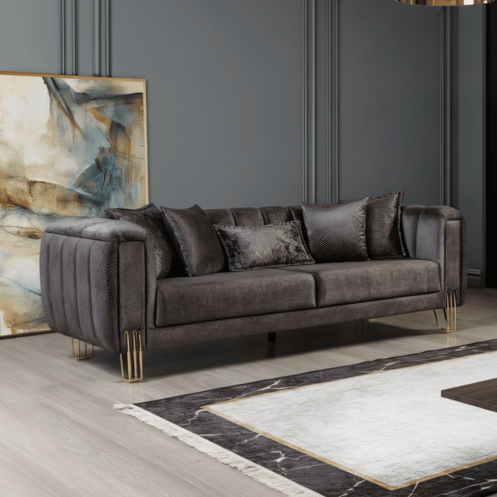 Gray sofa with decorative pillows in a room with abstract art and marble rug