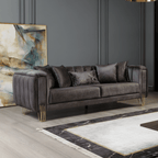 Gray sofa with decorative pillows in a room with abstract art and marble rug