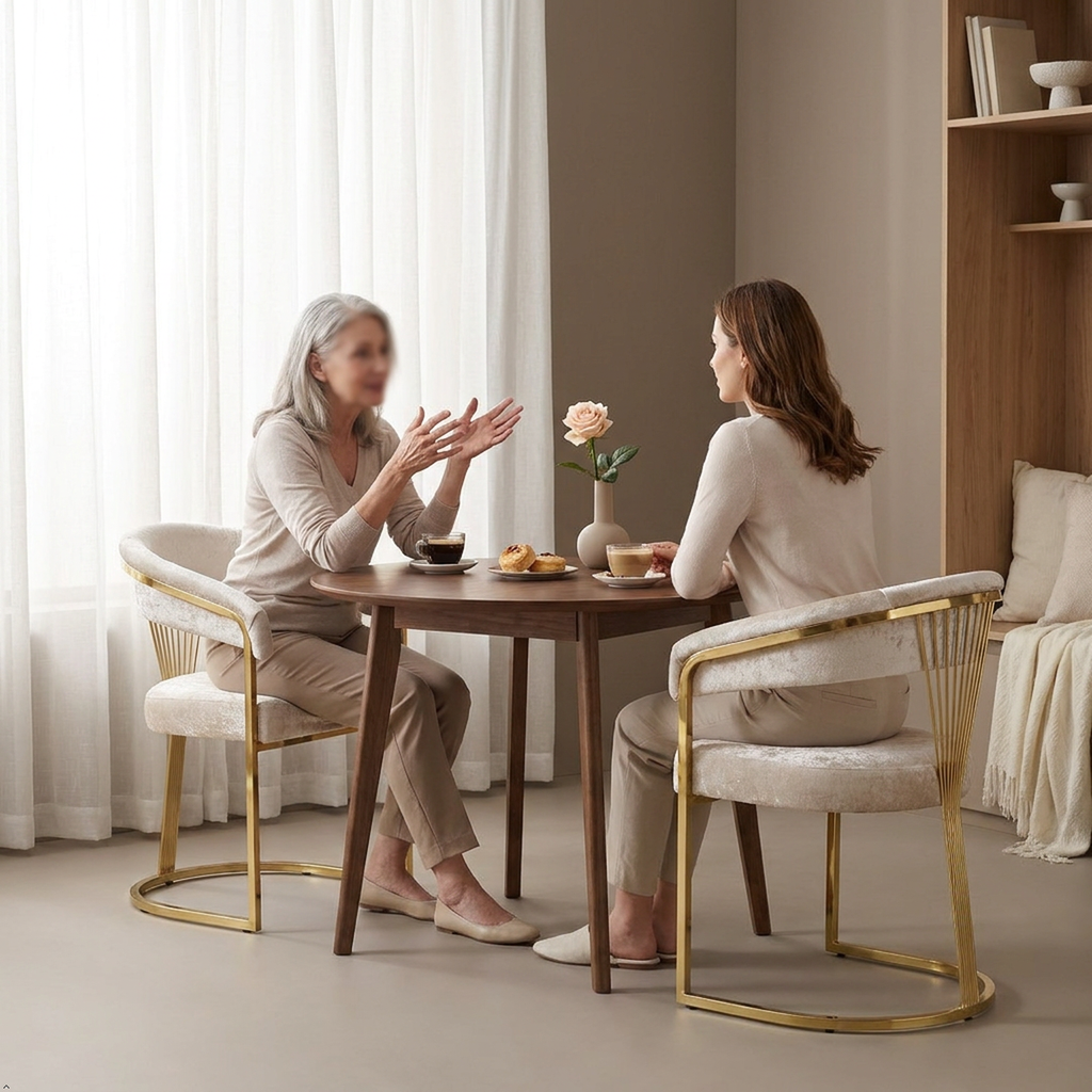 Gold set of 2 chairs in modern sun room 2 females chatting around a table sitting on BERCH dining chair 