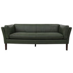 Green leather sofa on a white background