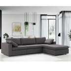 Gray sectional sofa in a modern living room with white walls and decor.