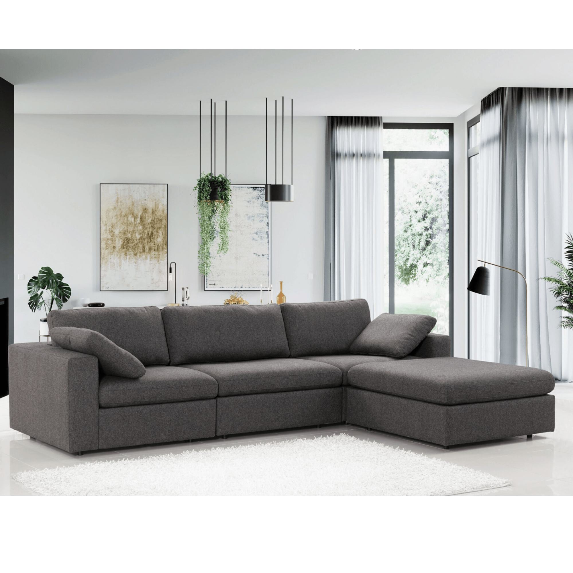 Gray sectional sofa in a modern living room with white walls and decor.