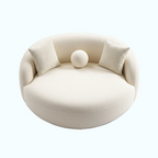 Round, cream-colored pet bed with soft texture on a white background