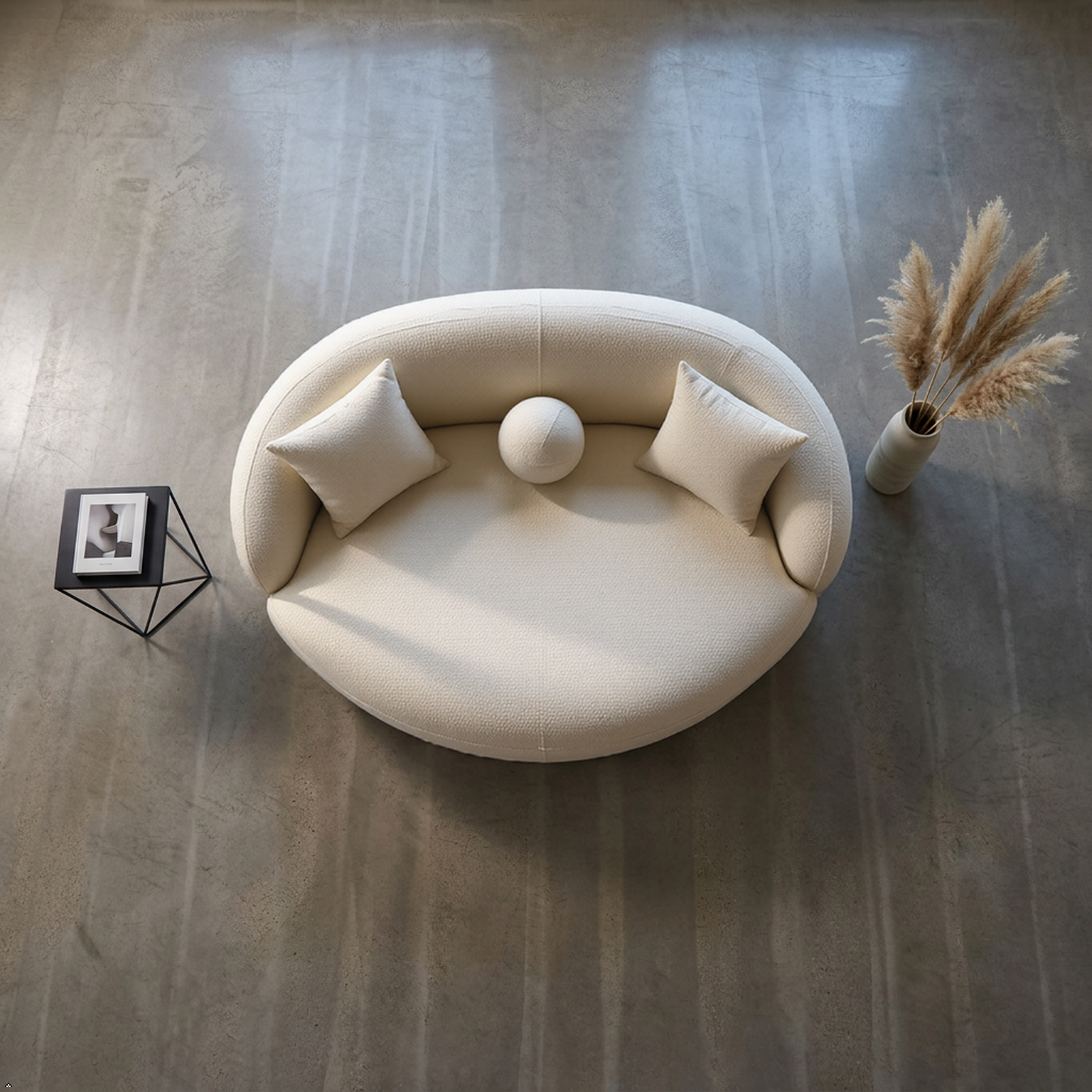 Round beige sofa with cushions on a wooden floor