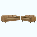 A mid-century modern leather sofa and matching loveseat in a warm tan color, shown on a plain white background.