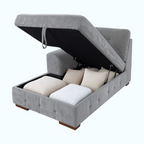 Gray upholstered ottoman with storage compartments and cushions on a white background