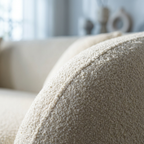 Close-up of a textured beige pillow on a blurred sofa background